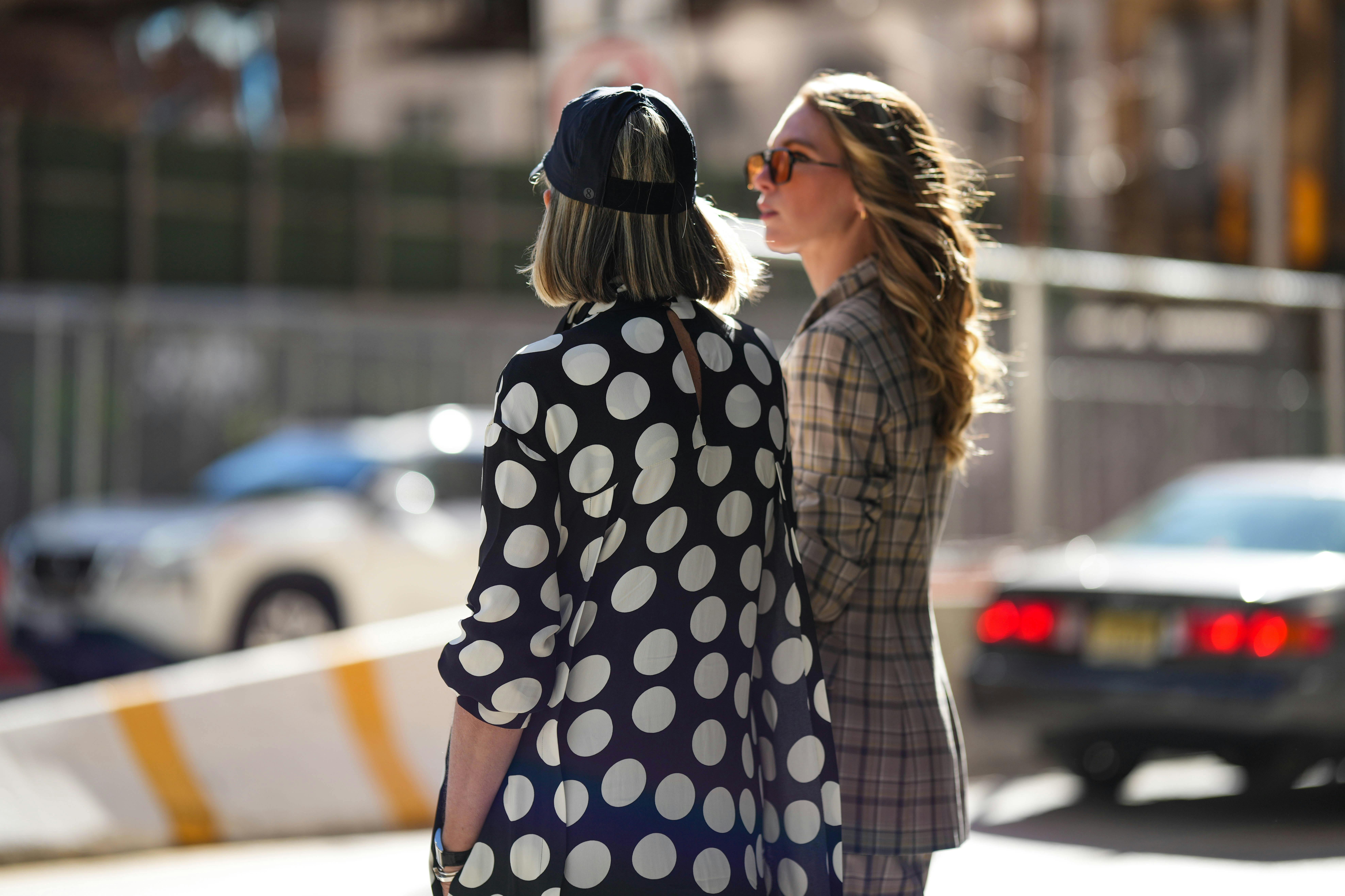 Two women stand on a street in New York City
