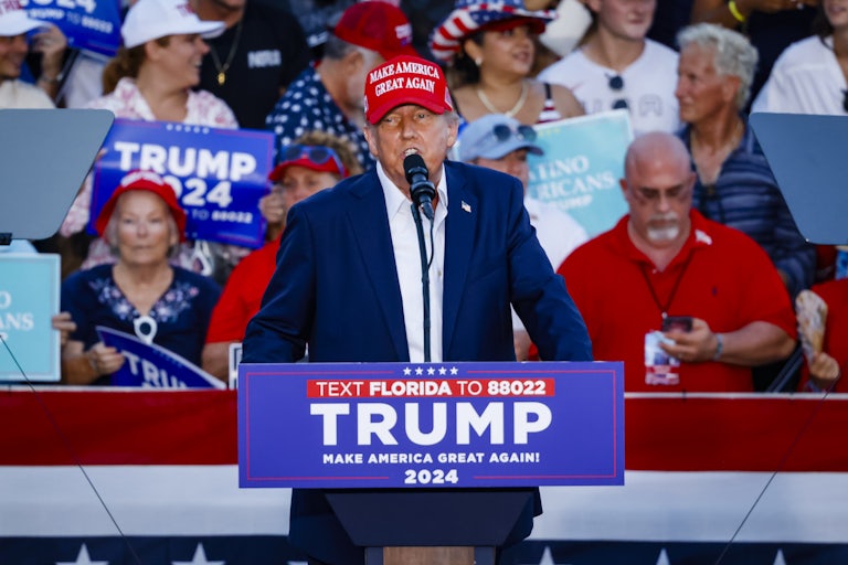 Donald Trump speaks at a podium