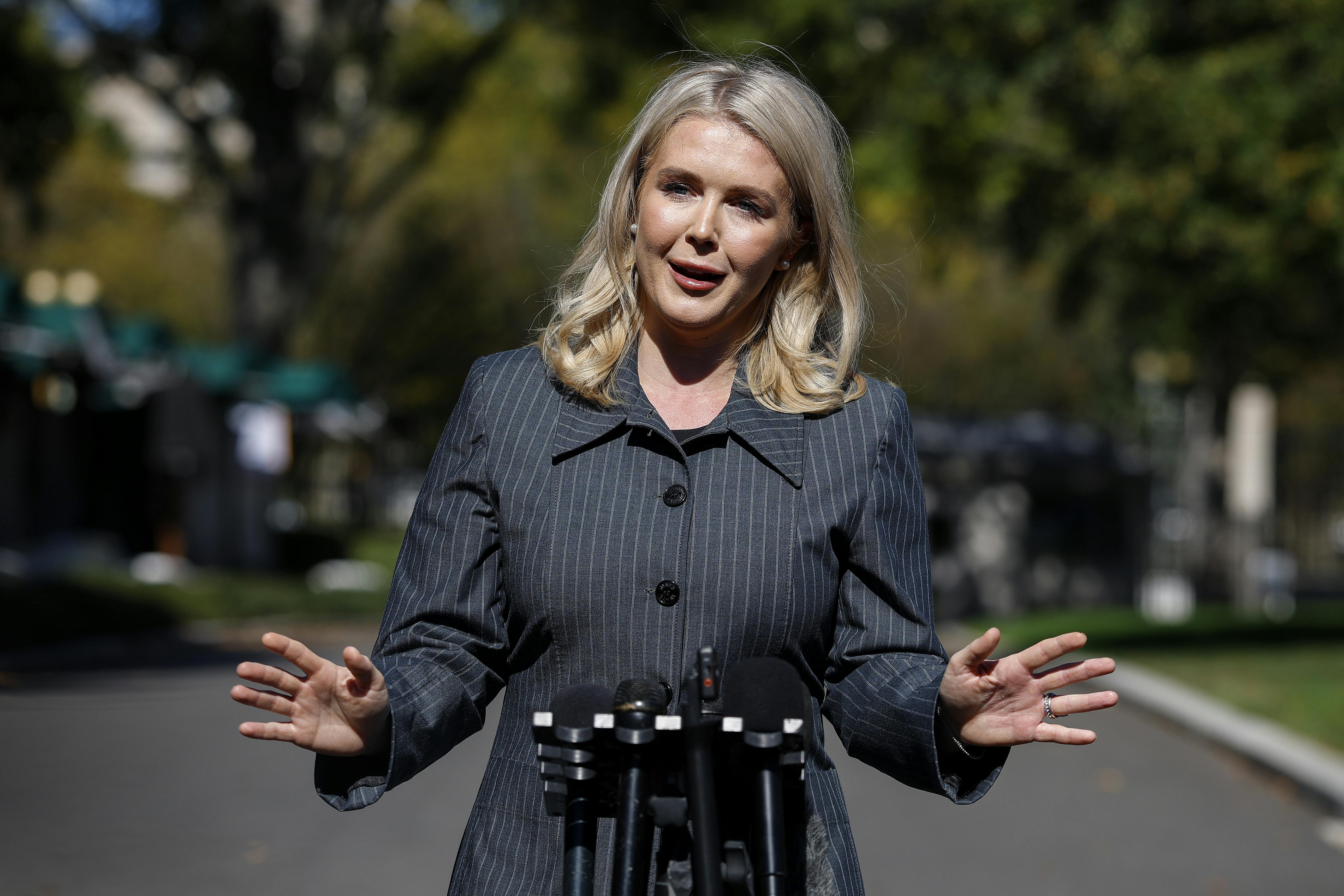 Karoline Leavitt gestures while speaking to reporters outside the White House