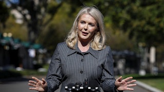 Karoline Leavitt gestures while speaking to reporters outside the White House