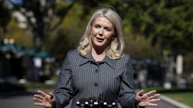 Karoline Leavitt gestures while speaking to reporters outside the White House