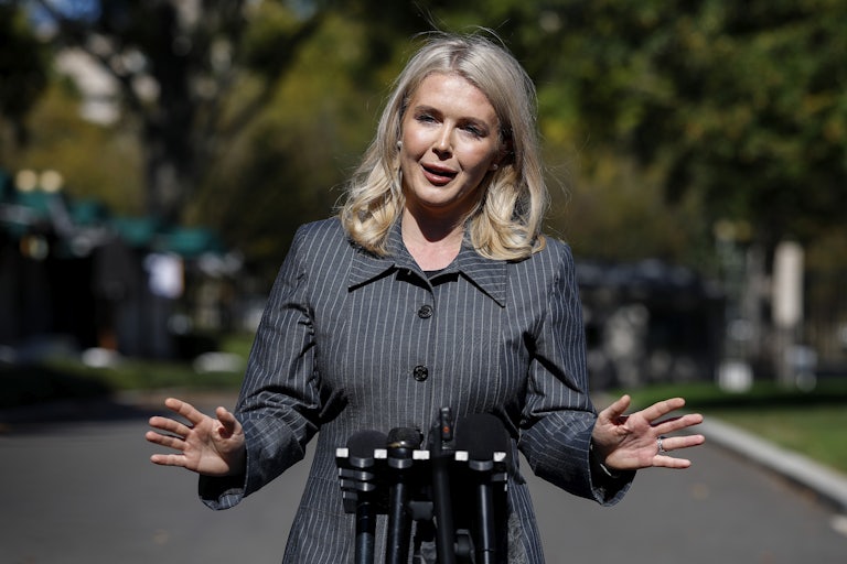 Karoline Leavitt gestures while speaking to reporters outside the White House