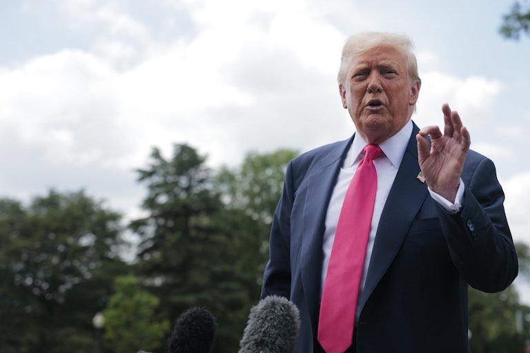 Donald Trump speaks to reporters (not pictured) outside.