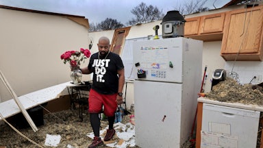 Man salvages belongings from his destroyed home after severe weather in Greater St. Louis