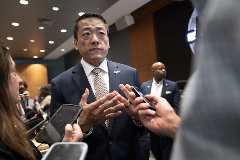 Texas House Democratic Caucus Chair Gene Wu speaks to reporters, who record on their phones.