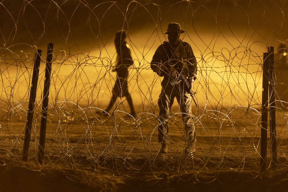 US soldiers walk along the southern border.