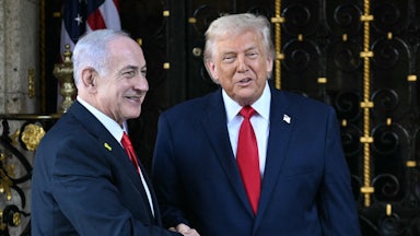 Israeli Prime Minister Benjamin Netanyahu and Donald Trump smile and shake hands