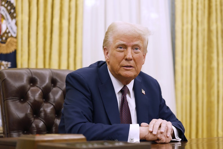 Trump folds his hands at the Resolute Desk