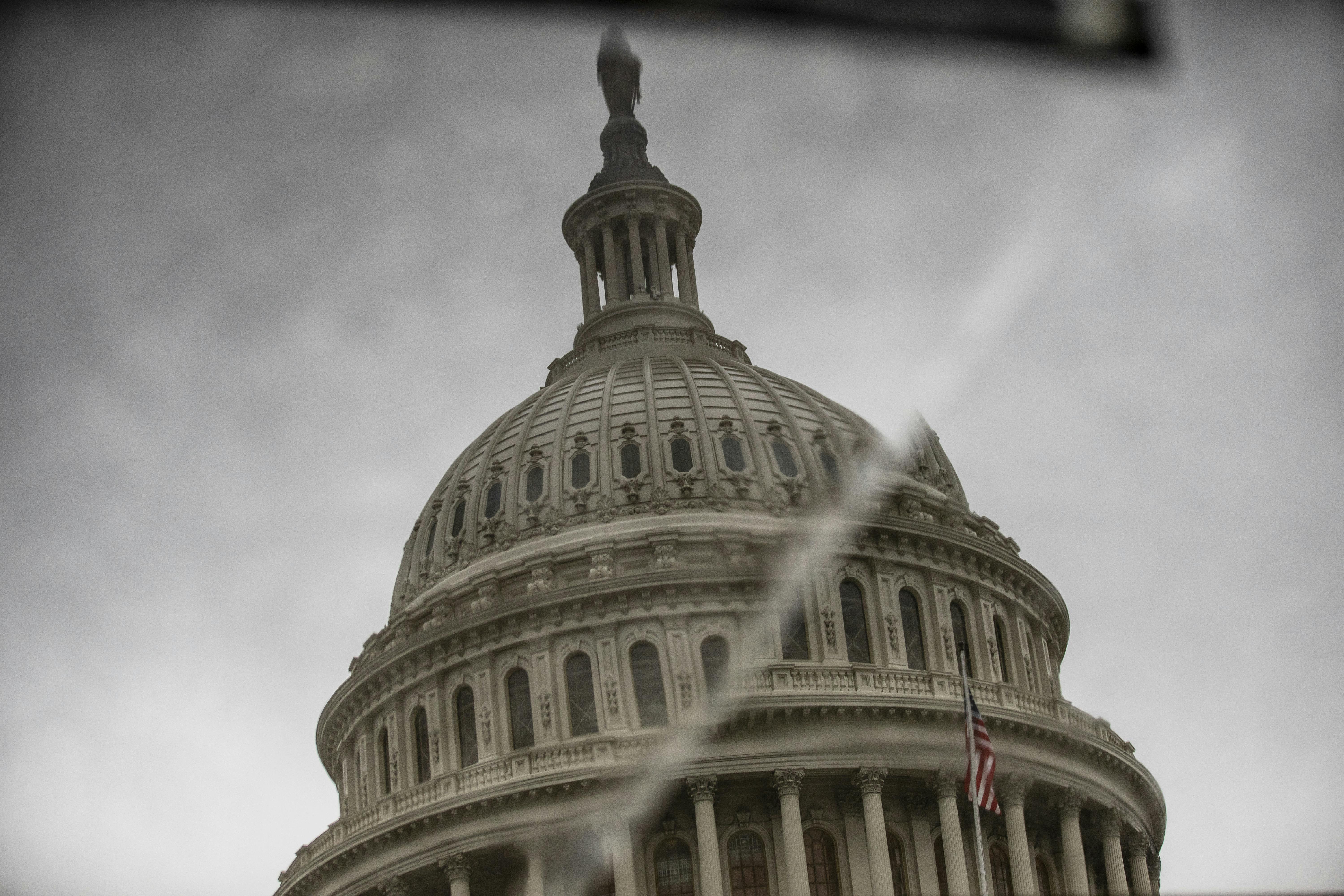 The dome of the U.S. Capitol is reflected in displaced stone, making it look like there's a crack running through it. 