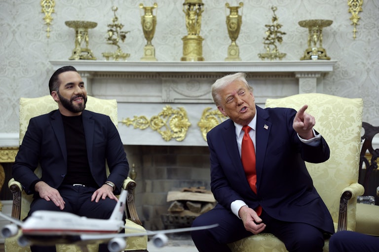 Nayib Bukele and Donald Trump hold a joint press conference in the Oval Office of the White House. Bukele smiles as Trump speaks and points at something not pictured.