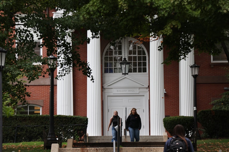 Two students walk on Tufts University’s campus.