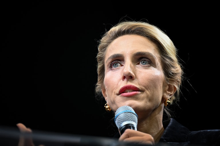 Clarissa Ward holds a microphone up to her face