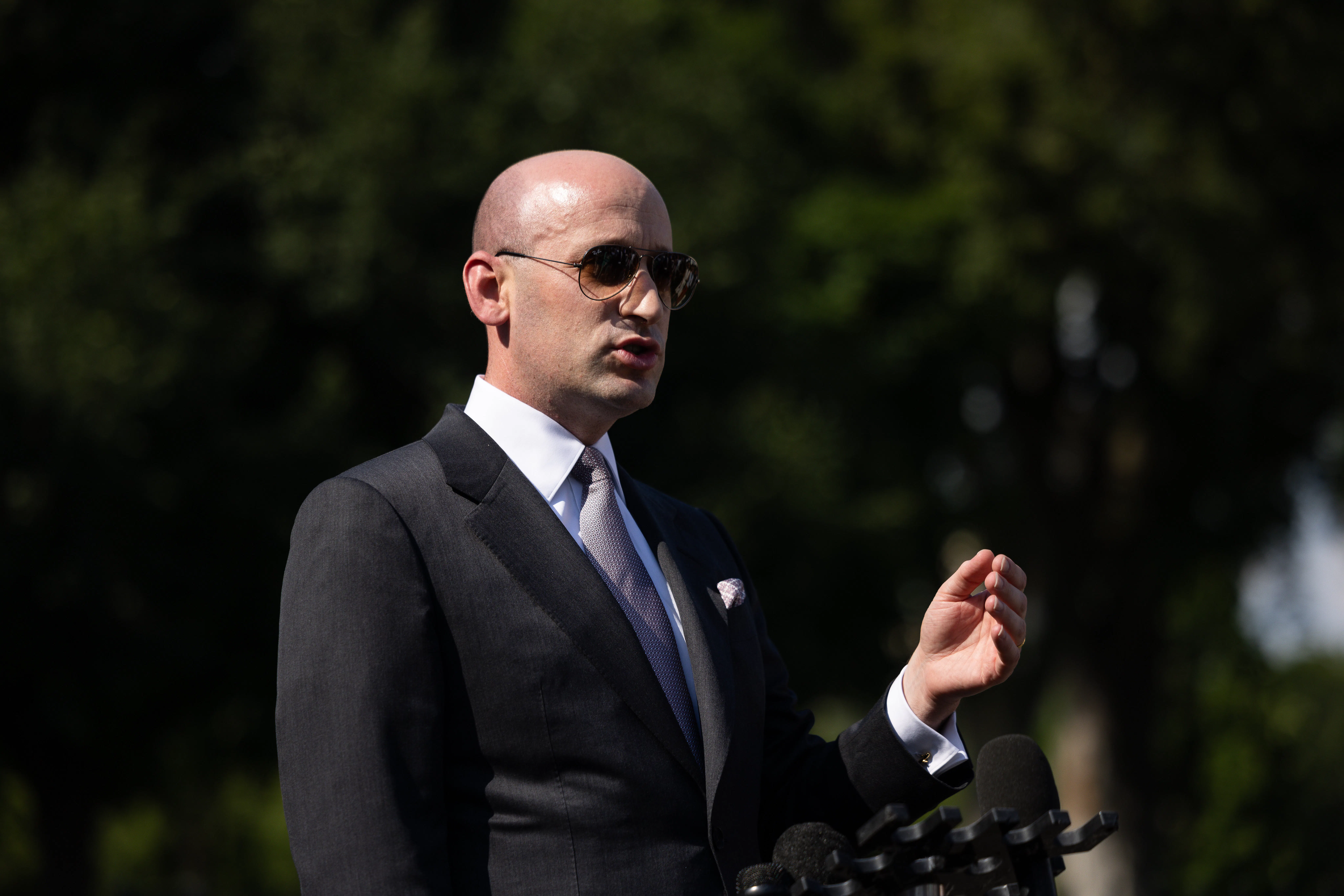 Stephen Miller gestures while speaking outside the White House