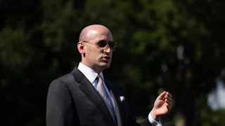 Stephen Miller gestures while speaking outside the White House