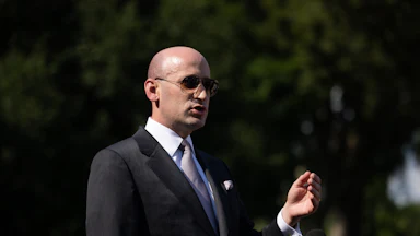 Stephen Miller gestures while speaking outside the White House
