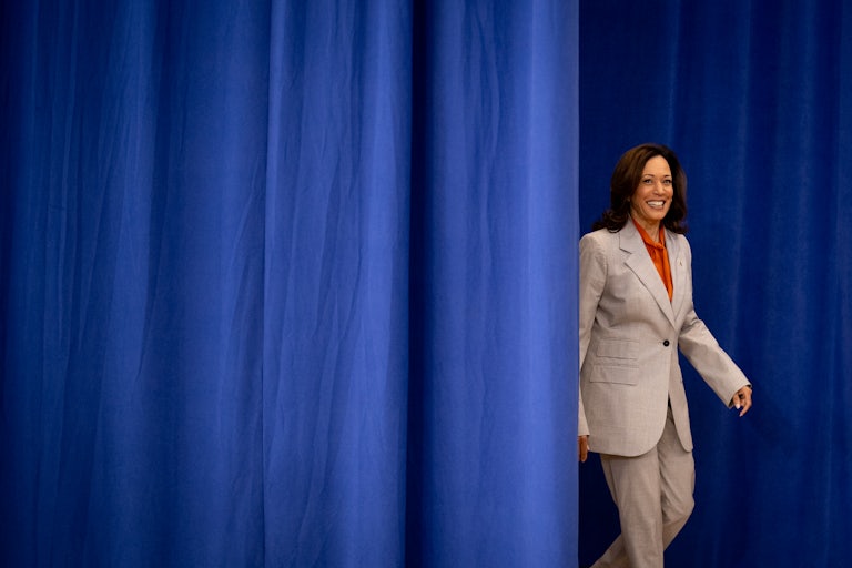 Kamala Harris walks out of curtains on a stage