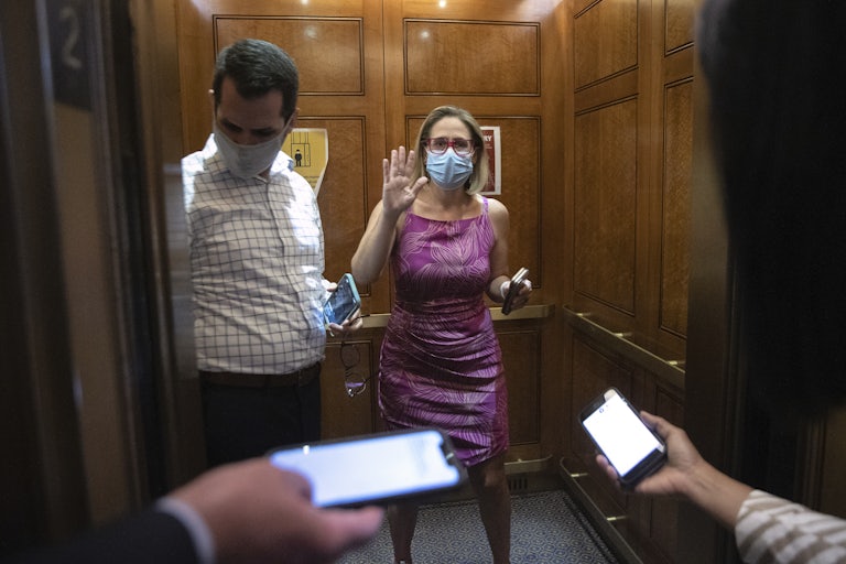 Kyrsten Sinema boards an elevator at the U.S. Capitol 