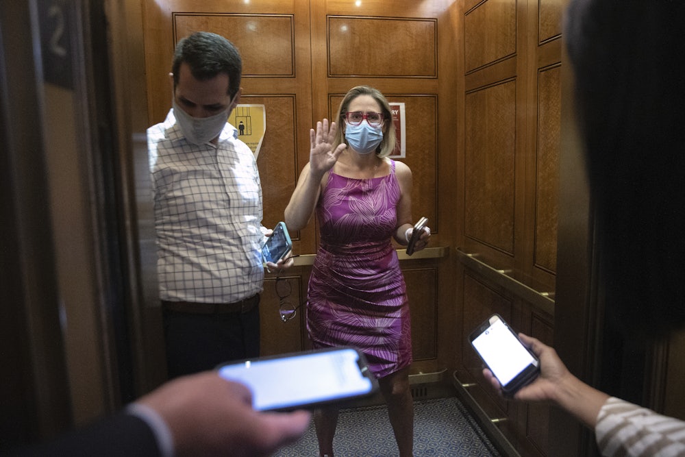 Kyrsten Sinema boards an elevator at the U.S. Capitol