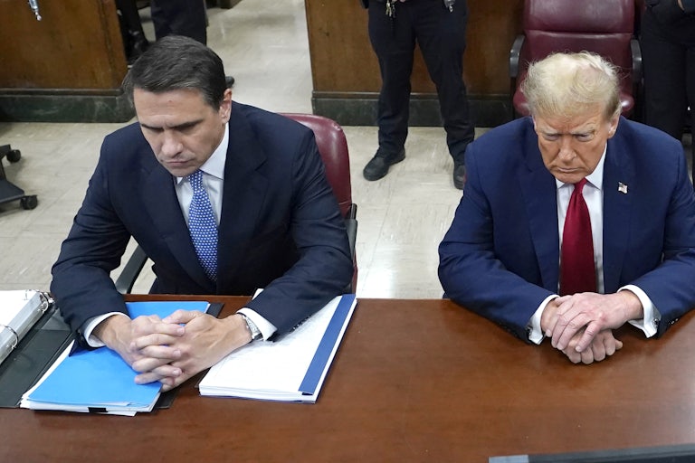 Shot from above of Todd Blanche and Donald Trump sitting side by side in court