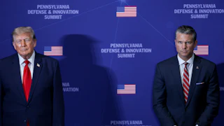 Donald Trump and Pete Hegseth stand in front of a backdrop that reads Pennsylvania Defense & Innovation Summit, a large gap between them.