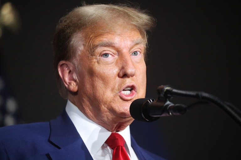 Donald Trump speaks into a microphone