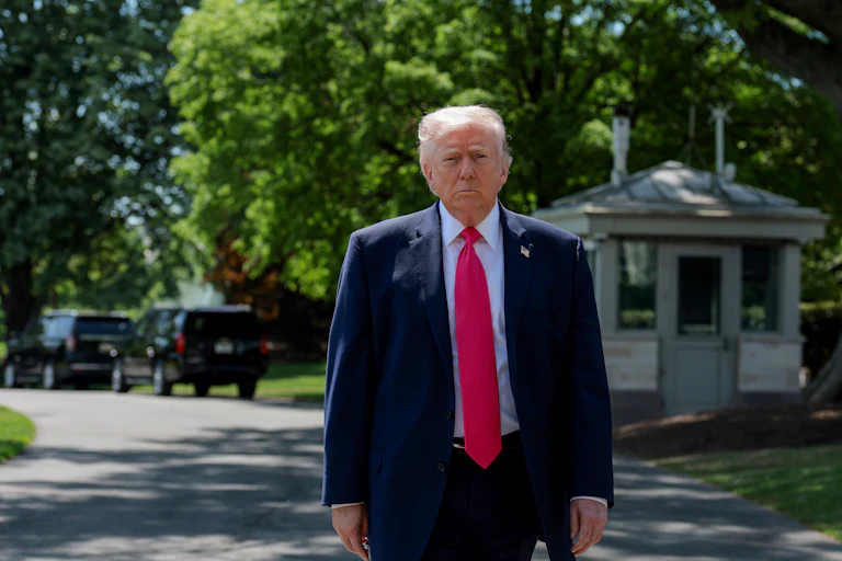 President Donald Trump stands outside the White House
