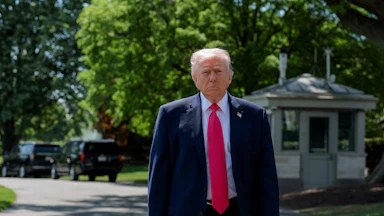 President Donald Trump stands outside the White House