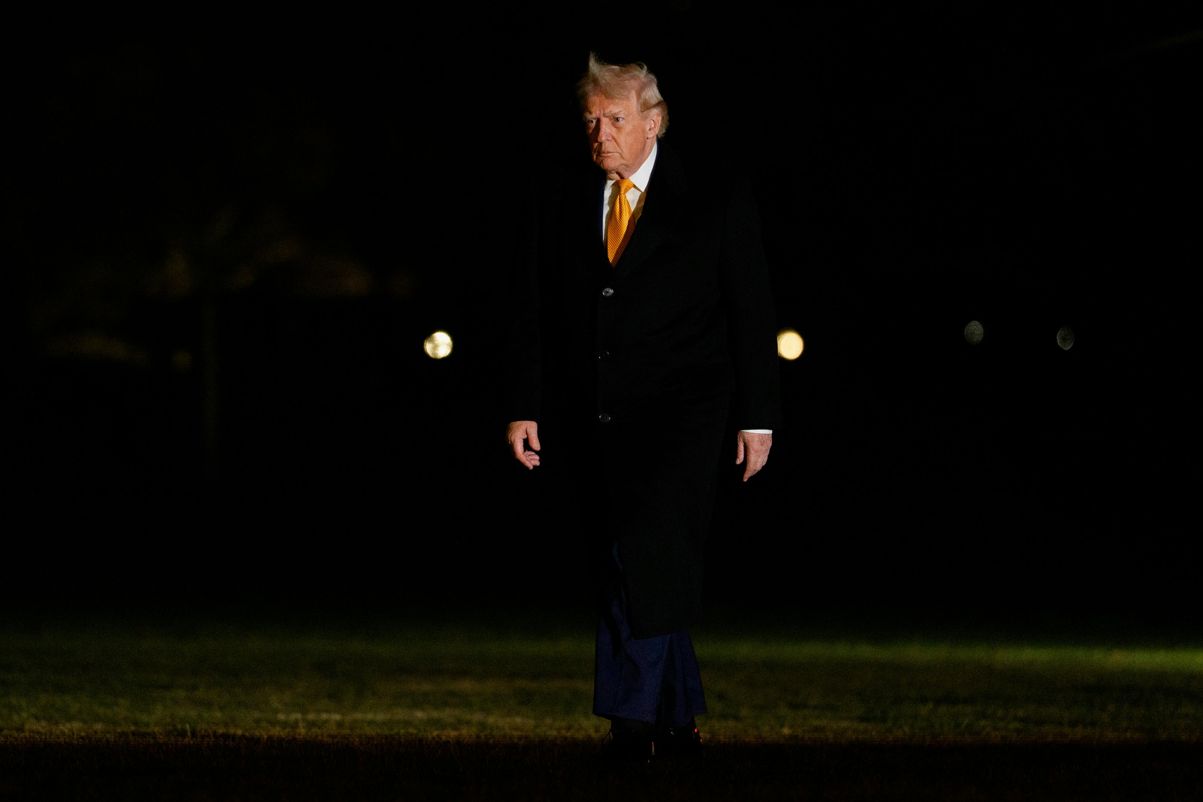 Donald Trump walks outside the White House