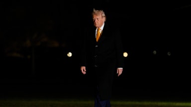 Donald Trump walks outside the White House