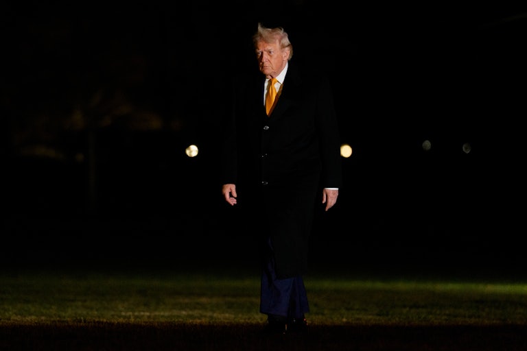 Donald Trump walks outside the White House