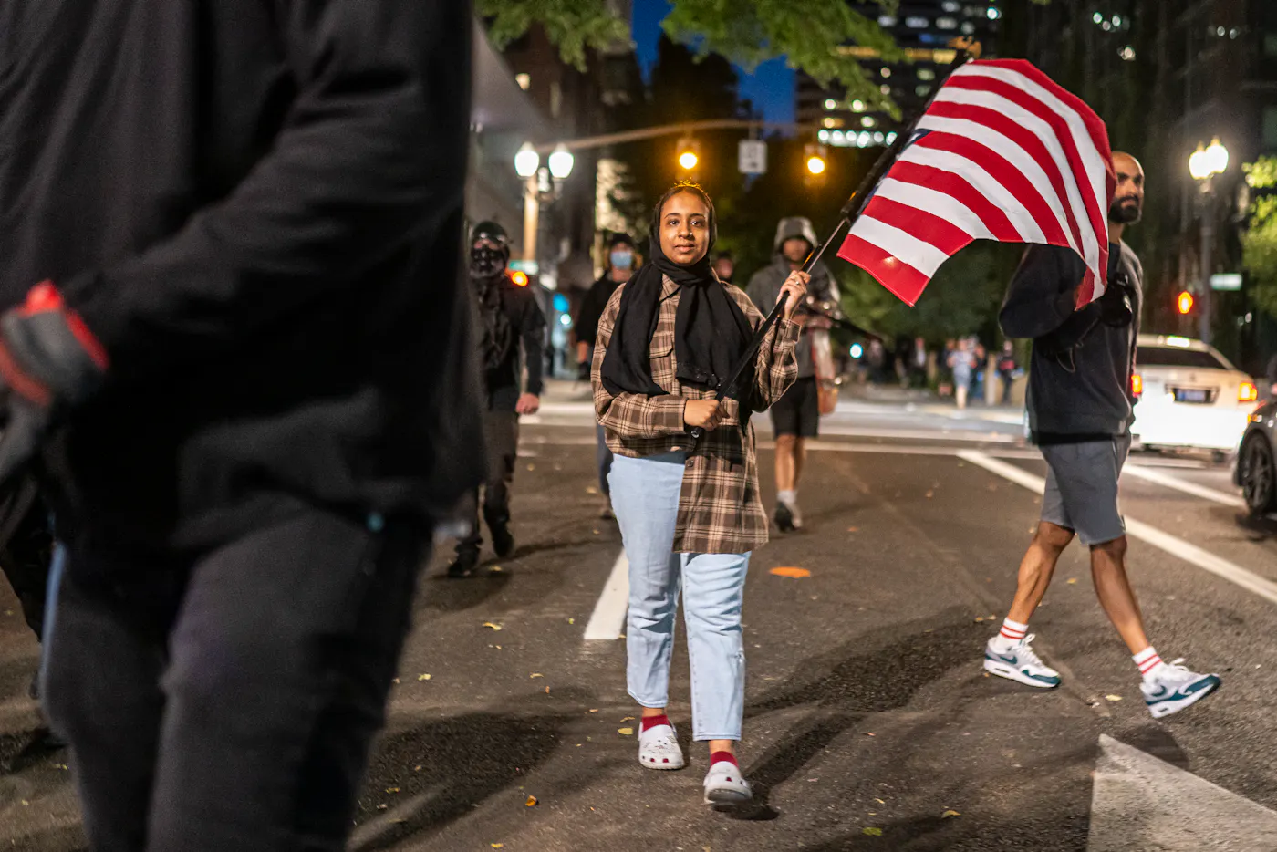 A photo of a protester carried an upside-down American flag in Portland, Oregon, in 2021.