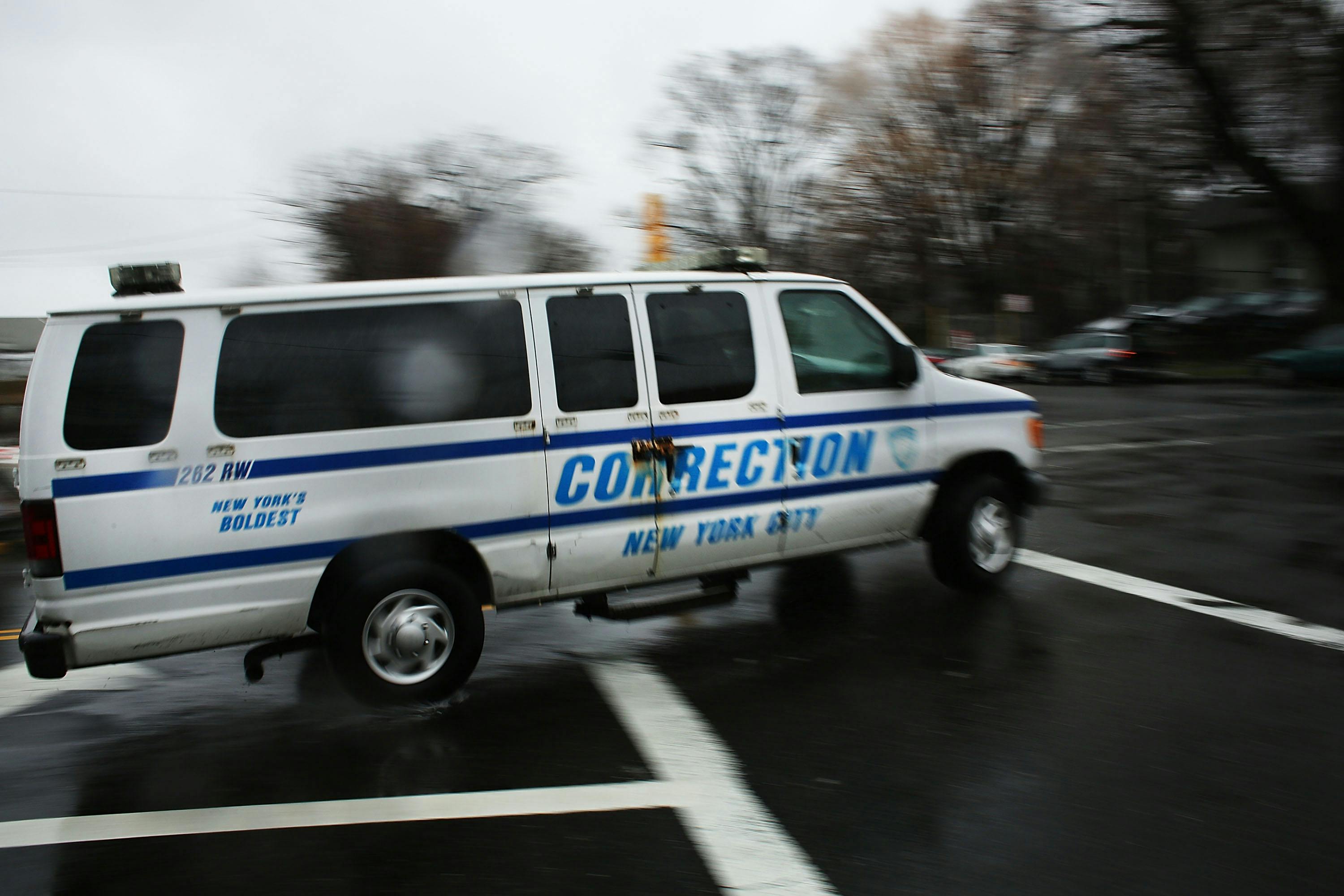corrections officers van enters Rikers Island