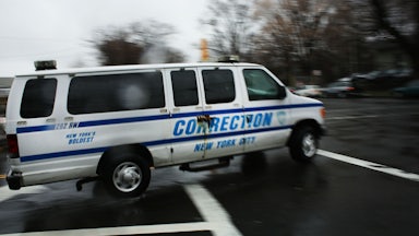 corrections officers van enters Rikers Island