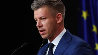 Hungarian Prime Minister-elect Péter Magyar speaks into microphones during a press conference