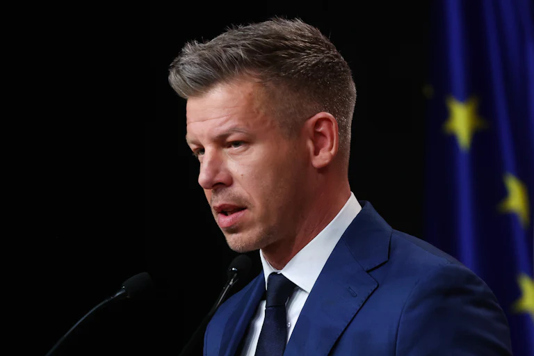 Hungarian Prime Minister-elect Péter Magyar speaks into microphones during a press conference