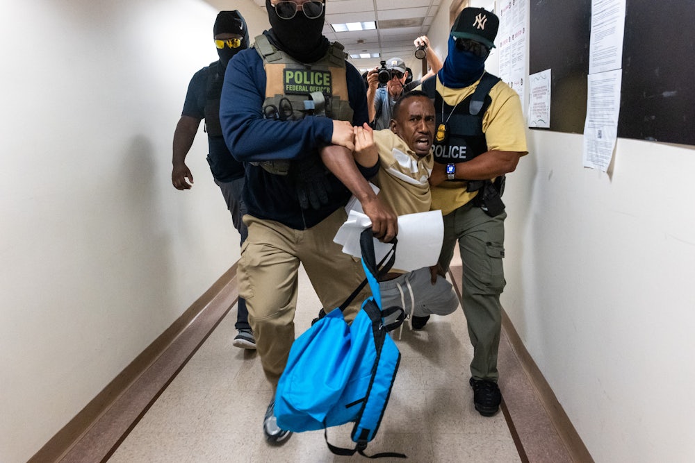 Federal agents, including members of ICE, drag a man away after his court hearing as they patrol the halls of immigration court at the Jacob K. Javitz Federal Building on July 24, 2025 in New York City.