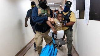 Federal agents, including members of ICE, drag a man away after his court hearing as they patrol the halls of immigration court at the Jacob K. Javitz Federal Building on July 24, 2025 in New York City.
