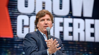 Tucker Carlson speaking on a mic.