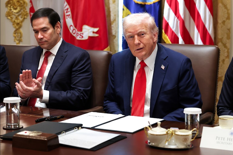 Secretary of State Marco Rubio claps while Donald Trump grins at his Cabinet meeting.