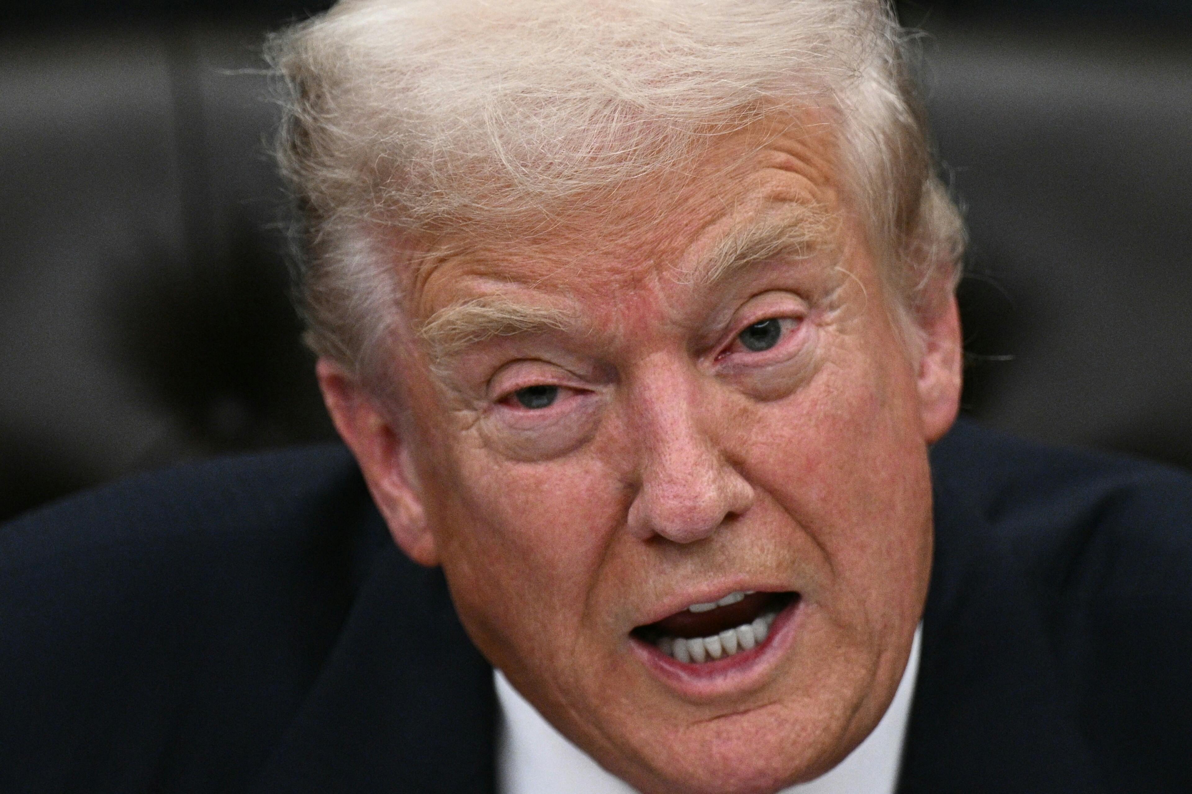 Donald Trump speaks while sitting in the Oval Office