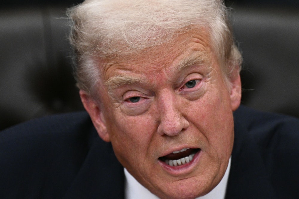 Donald Trump speaks while sitting in the Oval Office