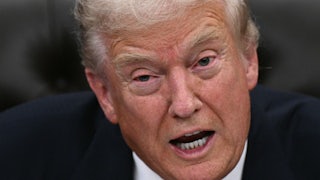 Donald Trump speaks while sitting in the Oval Office