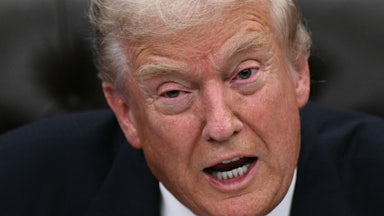 Donald Trump speaks while sitting in the Oval Office