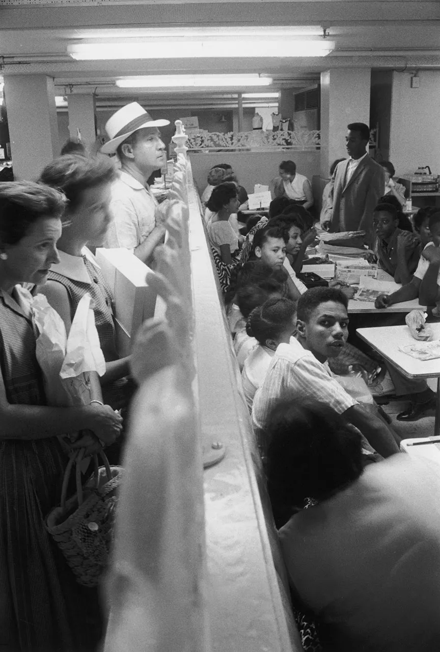 Protesters staging a sit-in challenging Plessy v. Ferguson's “separate but equal” doctrine