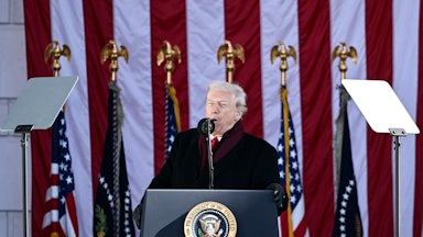 Donald Trump speaks at a podium during a ceremony at Arlington National Cemetery