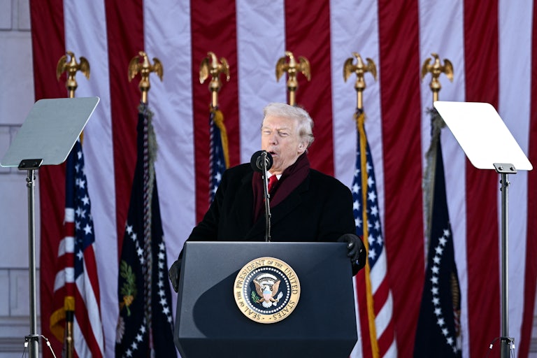 Donald Trump speaks at a podium during a ceremony at Arlington National Cemetery