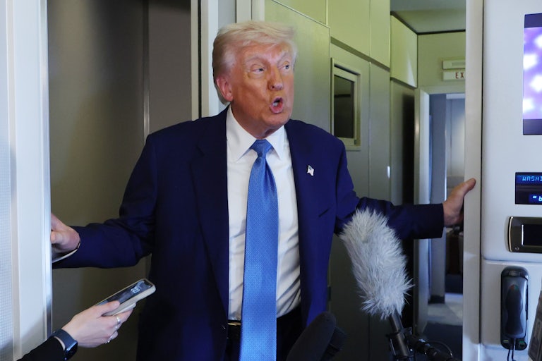 Donald Trump speaks to reporters on Air Force One