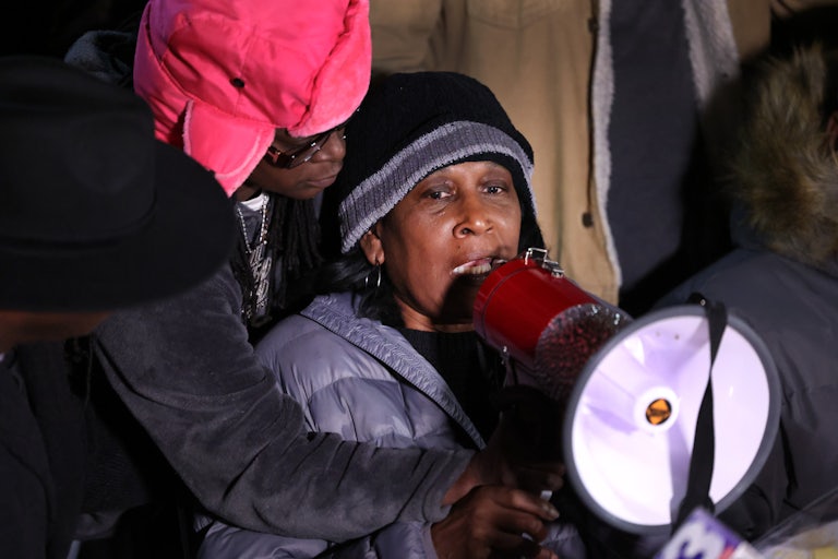 RowVaughn Wells speaks in a podium (wearing winter clothing, outdoors).