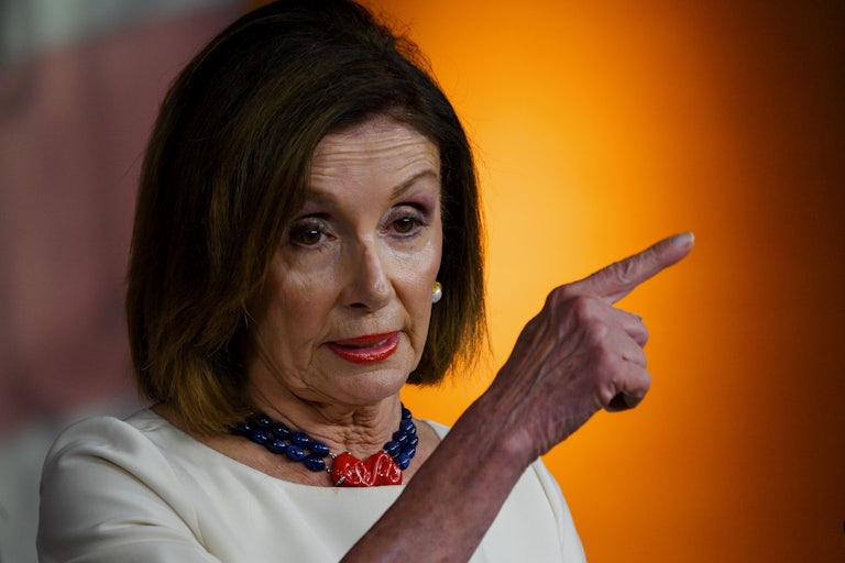 Representative Nancy Pelosi speaks and points a finger for emphasis.