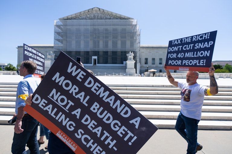 Protesters in front of the Supreme Court hold signs reading "We demand a moral budget not a death-dalign scheme" and "Tax the rich! Don't cut SNAP for 40 million poor people!"